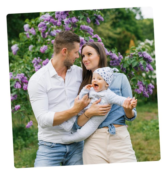 Couple holding the baby they welcomed through surrogacy